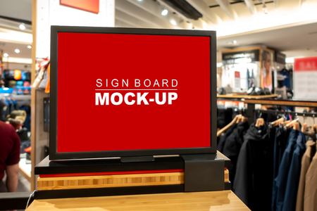 Mock up horizontal blank signboard in black frame   to show promotion or price at fashion clothes shop, Red screen empty space for insert text or advertisingの写真素材