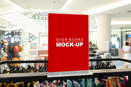 Mock up horizontal blank signboard in acrylic frame  to show promotion or price at fashion clothes shop, Red screen empty space for insert text or advertisingの写真素材