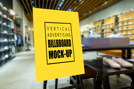 Mock up perspective of vertical advertising billboard   on wooden stand in showroom of sport shoe, yellow screen empty space for insert text and priceの写真素材