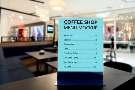 Mock up vertical blank menu in coffee shop   in acrylic frame placed on table, blue screen empty space for insert list menu and priceの写真素材