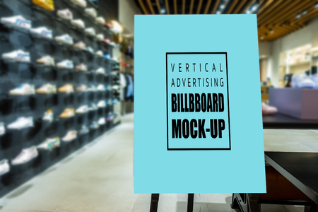 Mock up perspective of vertical advertising billboard  on wooden stand in showroom of sport shoe, blue screen empty space for insert text and priceの写真素材