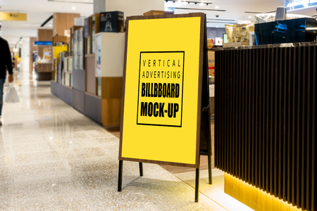 Mock up vertical blank billboard  , Advertising signage for promotion on the floor at corridors inside the department store, yellow screen empty space for insert text or mediaの写真素材