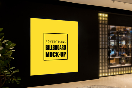 Mock up blank billboard , Advertising signage for promotion on black wall at aisle inside the department store, yellow screen empty space for insert text or mediaの写真素材