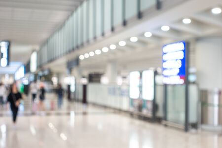 Background image with blurred people walking in airport area nearly gate and information boardの写真素材