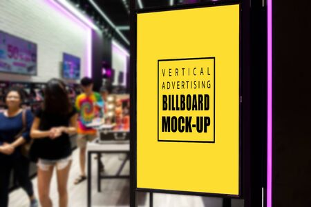 Mock up perspective blank vertical advertising signboard in black frame  at entrance of shopping mall, empty space for insert information or promotionの写真素材