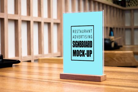 Mock up perspective blank vertical advertising signboard in acrylic frame   on table in Japanese style restaurant ,empty space for insert menu list or promotionの写真素材