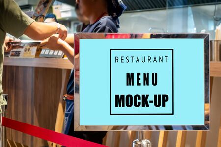 Mock up perspective blank horizontal signboard in metal frame  standing near counter in restaurant ,empty space for insert advertising or promotionの写真素材