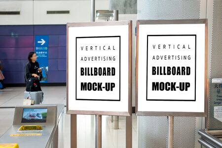 Mock up two blank vertical billboard in stainless steel frame  , Empty space for information or advertising at the entrance, blurred passenger in backgroundの写真素材