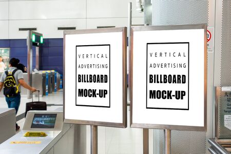 Mock up two blank vertical billboard in stainless steel frame  , Empty space for information or advertising at the entrance, blurred passenger in backgroundの写真素材