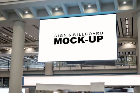 Mock up perspective horizontal billboard at airport terminal hanging from ceiling over walkway, empty space for advertising or public information, advertisement conceptの写真素材