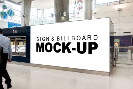Mock up large horizontal blank billboard   near ticket vending machine at airport, Empty space for information or advertising, blurred people walking in backgroundの写真素材
