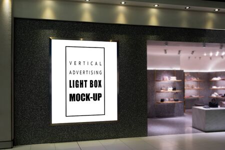Mock up large blank vertical billboard   placed near entrance and walkway in shopping mall, empty space for advertising or information, advertising conceptの写真素材