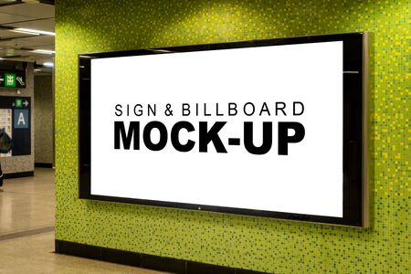 Mock up large blank perspective horizontal billboard in metal frame with clipping path on the beautiful wall of walkway in building ,empty space for insert advertising or mediaの写真素材