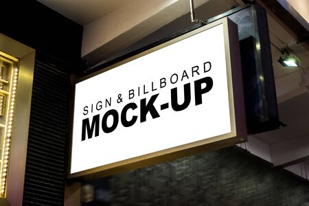 Mock up blank signboard with clipping path in metal frame is hanging from the ceiling over street walk at metro station, empty space for advertisingの写真素材