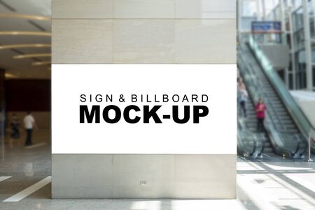 Mock up large blank billboard advertising on big pole   at front of escalator in shopping mall, empty space for insert graphic for promotion or informationの写真素材