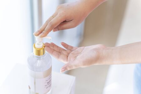 Young woman hand using wash hand sanitizer gel for protect virusの写真素材