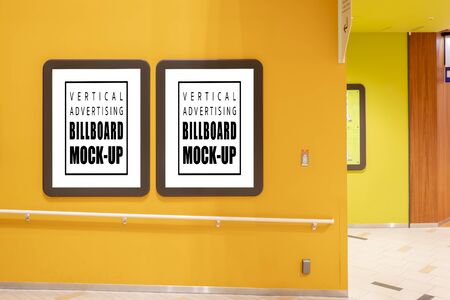 Mock up two blank poster with clipping path in brown frames on wall of walkway in shopping mall, empty space frames set for insert advertisement indoor poster or announcement informationの写真素材