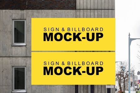 Mock up two blank large outdoor horizontal billboard with clipping path on building wall,  empty space for insert advertising design graphic or poster informationの写真素材
