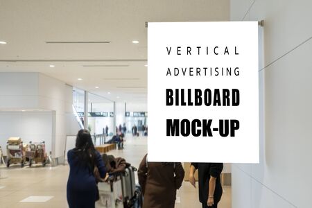Mock up vertical signboard on the wall over walkway in airport, empty space for insert advertising...