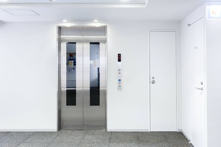 The Elevator in the modern building, closed door stand by near exit door, stand by on first floor,...