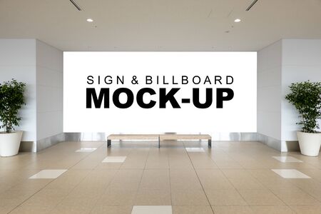 Mock up large horizontal billboard with clipping path on the wall in waiting area, has two wooden seat at front. Empty space for insert advertising graphic design or information, displayの写真素材