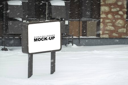 Mock up blank outdoors signboard with clipping path on metal pole for advertising poster at street on winter day, empty space for insert advertising or announcement informationの写真素材