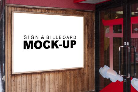 Mock up perspective blank signboard with clipping path on the wooden wall near the entrance, empty space for insert advertising or announcement informationの写真素材