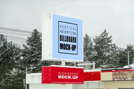 Mock up blank outdoors billboard and signboard with clipping path on metal pole for advertising poster over the roof on winter day, empty space for insert advertising or announcement informationの写真素材