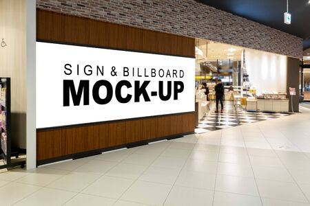 Mock up perspective blank large billboard with clipping path on the panel of the entrance food court in shopping mall, empty space for insert advertising or announcement informationの写真素材
