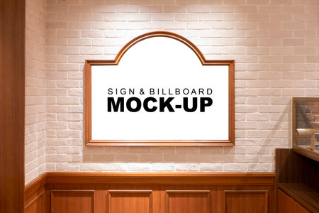 Mock up blank beautiful design of picture board with wooden frame  , hanging on brick wall at hotel, empty space for insert text or graphic designの写真素材