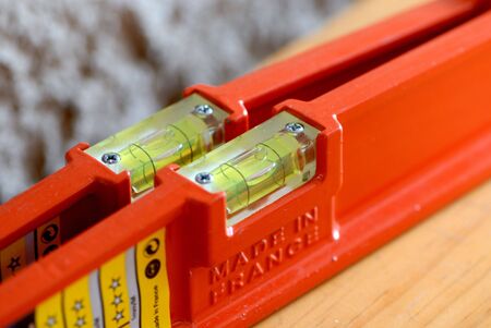 some orange's spirit level on the wood table 