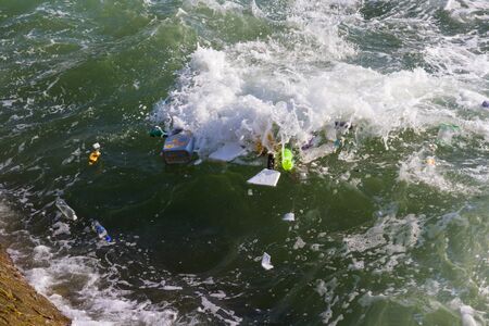 Garbage many pieces floating with ocean waves.