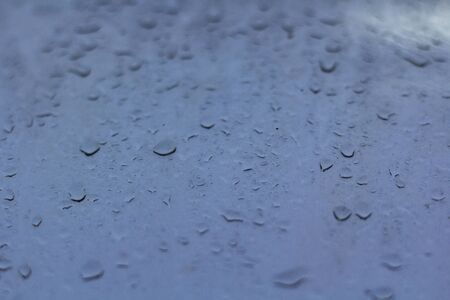 Rain drops on the glass surface.