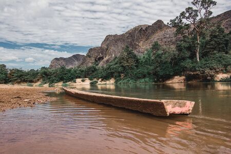 One old shipwreck is on the river in Laos.