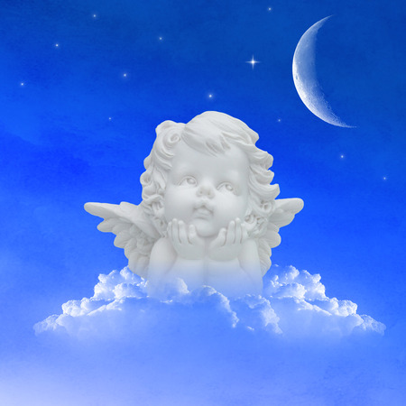angel on clouds in the night sky with moon and starsの写真素材