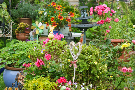 Colorful garden in summer with garden decorationsの写真素材