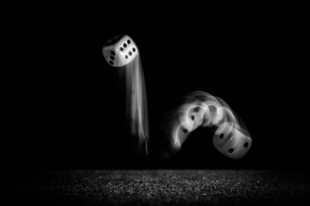 Jumping cubes in the dark - leaving light trails of their movementsの写真素材