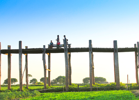 SUNSET MANDALAY : Unidentified people walk on U-Bein bridge, Mandalay, Myanmar. The U-Bein bridge is the longest teak bridge in the worldのeditorial素材