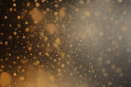 Abstract gold bokeh on black background. Christmas and New Year concept.の素材