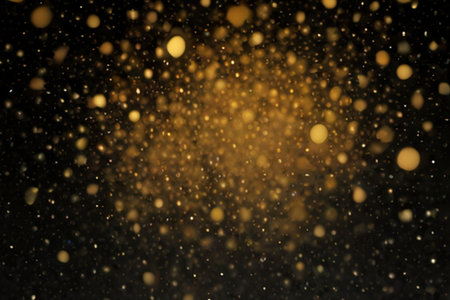 Abstract gold bokeh on black background. Gold glitter texture.の素材