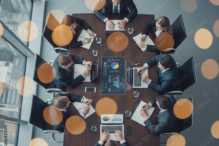 Top view of business people sitting at table in office and working togetherの素材