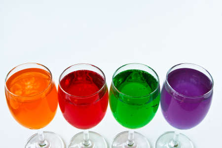 Glasses with colorful soda on a white background