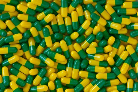 green and yellow capsule pills backgroundの写真素材