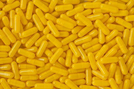  yellow capsule pills backgroundの写真素材