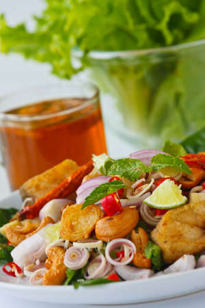 Herb salad with deep fried fish and shrimp (Thai fusion and healthy food)の写真素材