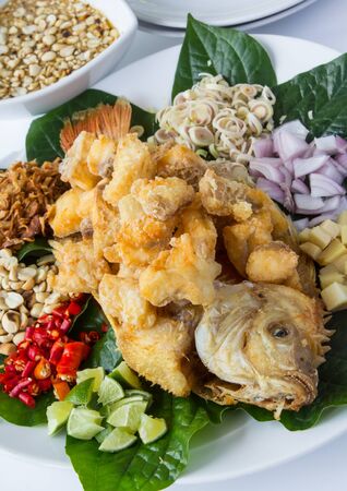 Thai  healthy food, Deep fried fish with Herb salad and peanut sweet sauce.の写真素材