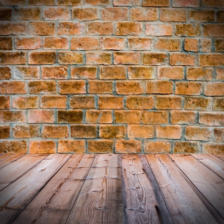 Red brick wall  with wooden floorの写真素材