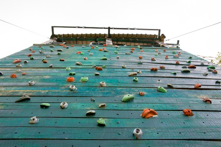 Grunge surface of an artificial rock climbing wall with toe and hand hold studs.の写真素材