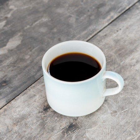 Coffee cup on old tableの写真素材