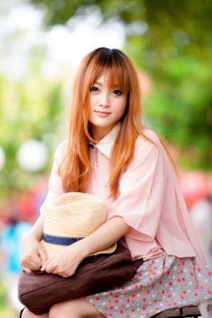 A shot of a beautiful asian woman outdoorの写真素材